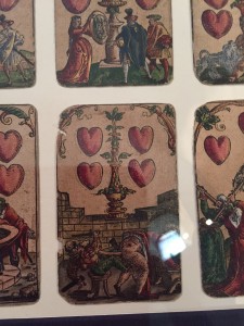 4 of Hearts depicting someone blowing a trumpet up his friends tush. 'k. 