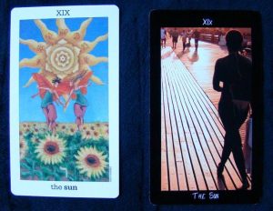 Left, Sun and Moon Tarot by Vanessa Decout. Right, Tarot of the Boroughs (!!!). Photo courtesy of Divine Whispers.Net